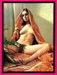 Naked woman draped in orange cloth holding ferns