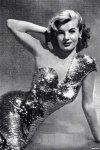 Sparkly sequined dress covering curves as she leans forward