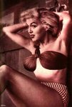 Bikini top girl with hands in hair looking off camera
